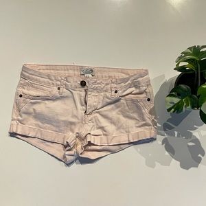 Pale pink jean shorts with small pocket details. Size 27.